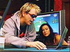In an early matchup between a human pro and a computer program, Phil Laak took on a poker bot in 2004. Girlfriend Jennifer Tilly, who’s also a poker player, looks on.